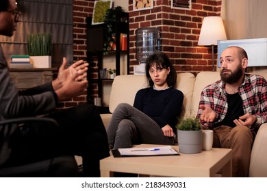 Portrait Of Worried Wife Attending Couple Therapy Session With Husband And Psychologist To Solve Marriage Difficulties. Receiving Professional Advice And Counseling To Help With Relationship Fight.