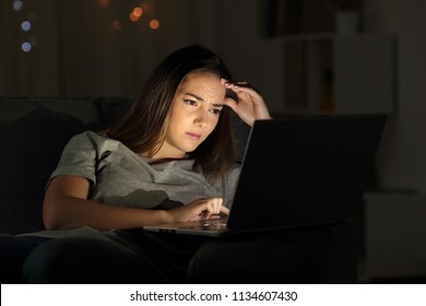 Portrait of a worried woman using a laptop in the night at home - Shutterstock ID 1134607430