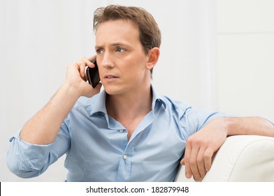 Portrait Of Worried Young Man On The Phone