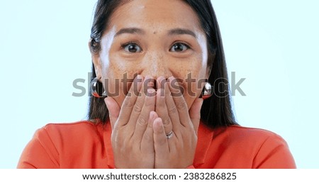 Portrait, wow and surprise with an asian woman in studio on a blue background to hear gossip or an announcement. Face, emoji and shock with a mind blown young person looking amazed by fake news