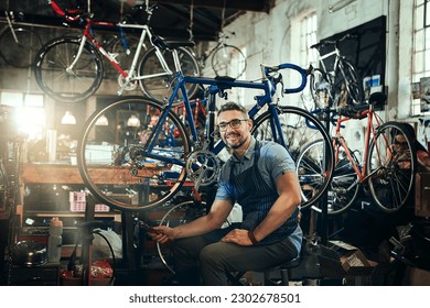 Portrait, wrench and smile of repair man in bicycle shop, store or cycling workshop. Face, bike mechanic and male person, happy business owner or mature technician with glasses and confidence. - Powered by Shutterstock