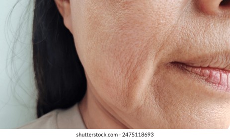 portrait the wrinkle and Flabby skin beside the mouth, dark spots and blemish, scar and freckles, wrinkled and loose on the face of middle aged women 55 years old, health care and beauty concept. - Powered by Shutterstock