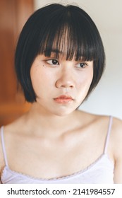 Portrait Of Young Adult Asian Woman After Self Care. Hair Bangs Cut On Face. Authentic People And Asia Skin. Wellness Mental Health Lifestyle Concept.