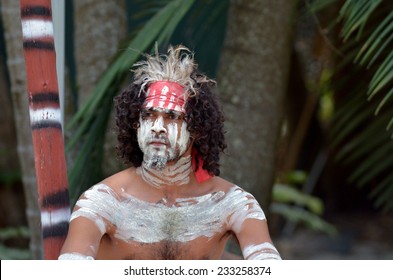 Portrait Of A Young Adult Australian Aboriginal Warrior Man Covered With Body Paint During An Aboriginal Australia Culture Show In Tropical Far North Of Queensland, Australia. Real People. Copy Space