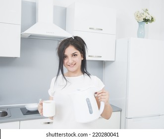 Portrait Of Young Adult Brunette Asian Woman Making Tea Or Green Tea On Kitchen Room Interior Background Empty Copy Space For Inscription Girl With Coffee Cup