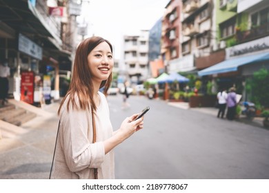 Portrait of young adult business asian working woman using mobile phone application for calling taxi transports. People living in city lifestyle concept. - Powered by Shutterstock