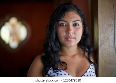 Portrait Of A Young Adult Girl Standing In A Room.