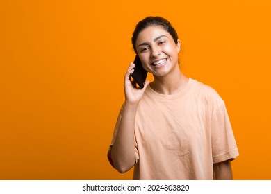 Portrait Of Young Adult Indian Woman Speak Mobile Phone