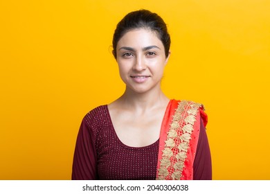 Portrait Of Young Adult Indian Woman In Sari Yellow Background