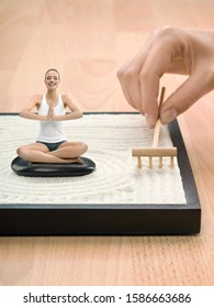 Portrait Of Young Adult Woman Meditating In Desktop Zen Garden, Digital Composite