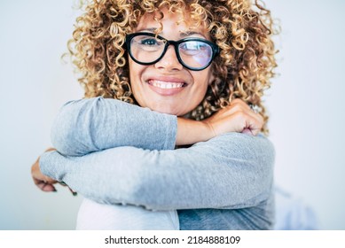 Portrait Of Young Adult Woman Smiling At The Camera And Wear Glasses. Blonde Curly Long Hair Female Enjoy Life. Happy And Cheerful Lady Smile. Front View Of Lady With Confident And Nice Expression