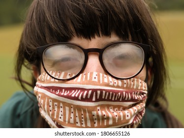 Portrait Of Young Adult Woman Wearing Protective Mask And Foggy Glasses. 