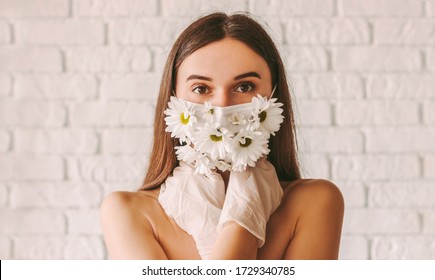 Portrait Young Affectionate Woman Posing In Protective Gloves And Summer Medical Face Mask. Beautiful Tender Girl Wearing Protective Face Mask With Flowers And Latex Gloves. Natural Female Beauty