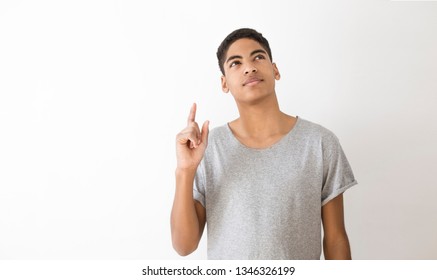 Portrait Of A Young African American Black Man Thinking Over An Idea. Attractive Thinking Teenager, Student. Pensive Guy On A White Background.  