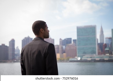 Portrait Of Young African American Business Man Looking At NYC Skyline, Photographed In NYC In September