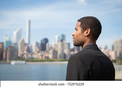 Portrait Of Young African American Business Man Looking At NYC Skyline, Photographed In NYC In September