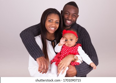 Portrait Of A Young African American  Couple With Her Baby Girl