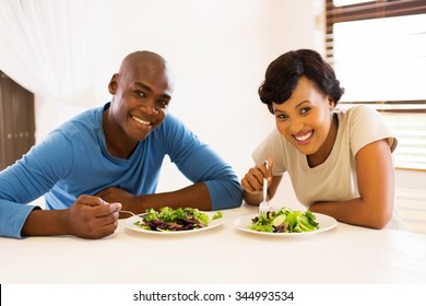 Portrait Of Young African American Couple Eating Healthy Salad For Lunch