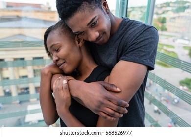 Portrait of young African American couple in love posing together indoors