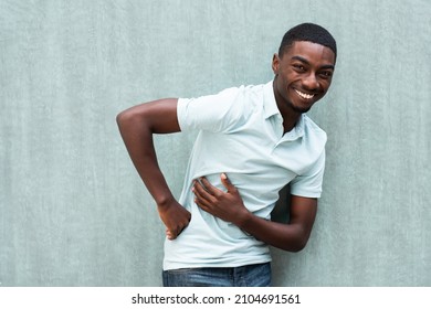 Portrait Young African American Holding Stomach With Hand And Laughing 