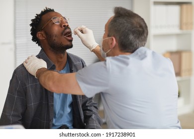 Portrait Of Young African American Man Taking Covid Test In Vaccination Center Or Clinic, Copy Space