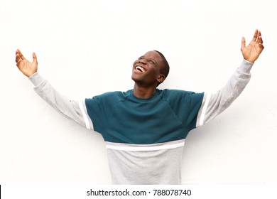 Portrait Of Young African American Man Looking Up With His Arms Wide Open On White Background