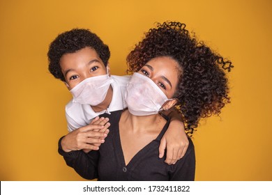 Portrait Of Young African American Mother With Toddler Son Using Mask. Mother And Son Wearing Mask To Protect Covid 19, Quarantine. Stay At Home Concept. 