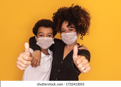 Portrait Of Young African American Mother With Toddler Son Using Mask. Mother And Son Wearing Mask To Protect Covid 19, Quarantine. Stay At Home Concept. 