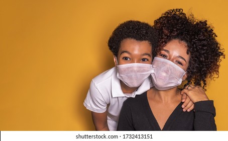 Portrait of young African American mother with toddler son using mask. mother and son wearing mask to protect covid 19, quarantine. Stay at home concept with copy space  - Powered by Shutterstock