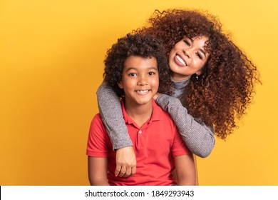 Portrait of young African American mother with toddler son. Yellow background. Brazilian family.
 - Shutterstock ID 1849293943