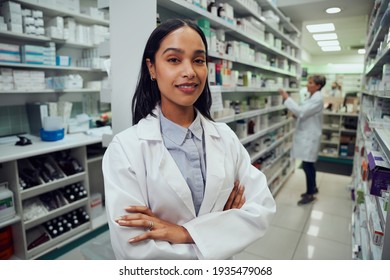 Portrait of young african american pharmacist standing between aisle in chemist - Powered by Shutterstock