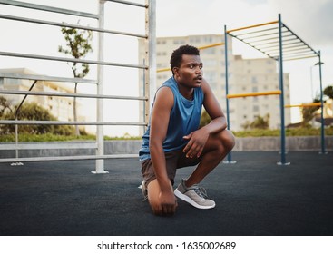 Portrait of young african american sports man relaxing outdoors after workout in public gym park  - Powered by Shutterstock