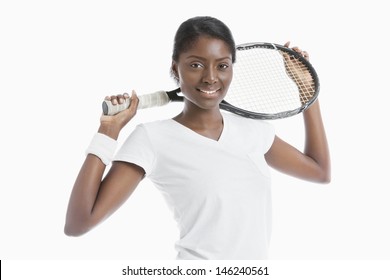 Portrait of young African American woman holding racket over white background - Powered by Shutterstock