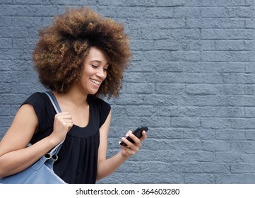 Portrait Of Young African American Woman Smiling With Cellphone