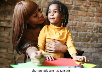 Portrait of a young African American woman and her daughter. drawing and communicate.  - Powered by Shutterstock