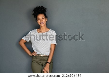 Similar – Image, Stock Photo Portrait of a woman with short jeans, colourful blouse and dark jacket standing in front of a ramshackle wall with graffiti