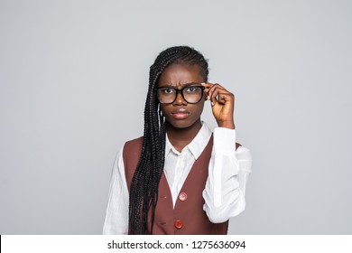 Portrait of young african business woman wearing glasses standing looking camera over grey background - Shutterstock ID 1275636094