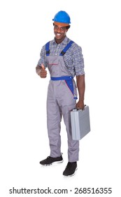 Portrait Of A Young African Craftsman Showing His Thumb Up Over White Background