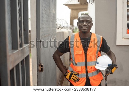 portrait of young african engineer holding his helmet