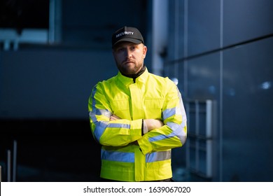 Portrait Of Young African Male Security Guard Standing Arms Crossed - Powered by Shutterstock