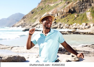 Portrait Of Young African Man Dancing At The Beach On Summer Day