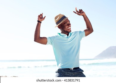 Portrait of young african man having fun at the beach on summer day - Powered by Shutterstock