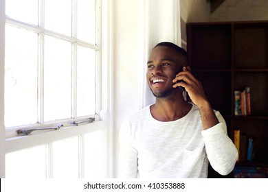 Portrait Of Young African Man At Home Making A Phone Call