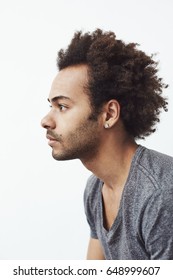 Portrait Of Young African Man In Profile Over White Background.