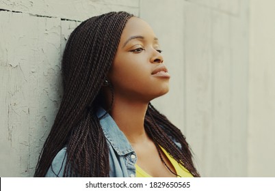 Portrait of young african woman in casual over city background
