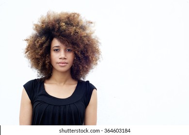 Portrait Of Young African Woman With Curly Afro Hair Standing Against White Background