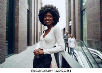 Portrait of young african woman with hairstyle smiling in urban background - Powered by Shutterstock