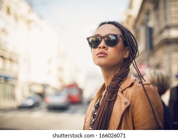 Portrait of a  young African woman wearing sunglasses outdoors. - Powered by Shutterstock