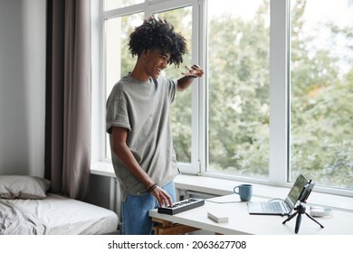 Portrait of young African-American man playing music at home and recording video or livestream, copy space - Shutterstock ID 2063627708