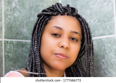 Portrait of a young afro woman with box braids. Concept of self esteem, attitude, confidence, determination, imperturbable.